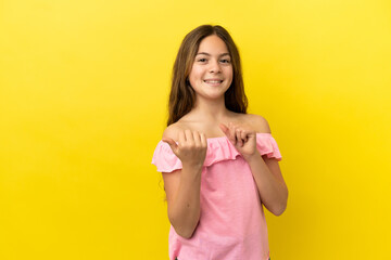 Little caucasian girl isolated on yellow background pointing to the side to present a product