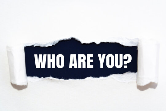 Naklejki Who are you? question written under torn paper.