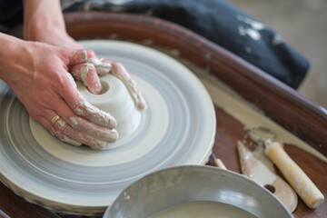 Female Potter creating a earthen jar on a Potter's wheel