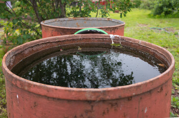 a barrel of rainwater for irrigating flowers and gardens