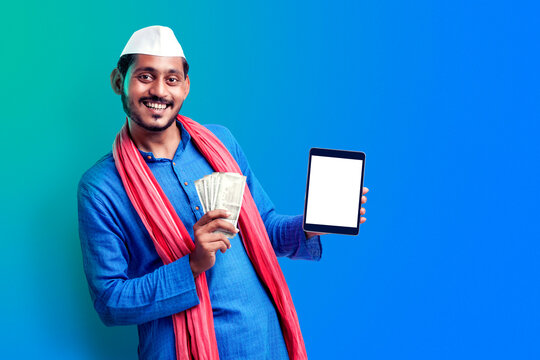 Happy Young Indian Farmer Showing Tablet And Money.