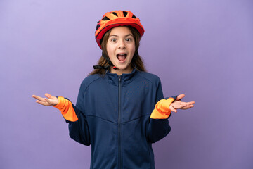 Little caucasian girl isolated on purple background with shocked facial expression