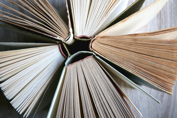 Vintage hardcover books on a wooden table. Top view.