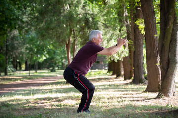 Senior jogger by lake in morning time stretching