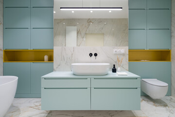 Fototapeta na wymiar Blue and gold furniture in bathroom