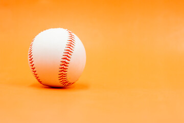 Baseball is on orange background
