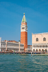 Fototapeta na wymiar Full size view of Campanile Bell Tower at San Marco square in Venice, Italy, at sunny day and deep blue sky.
