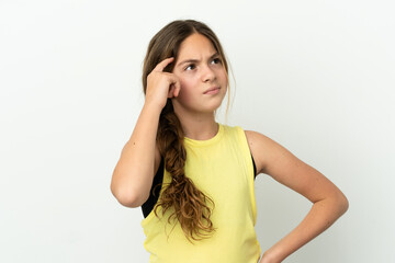Little caucasian girl isolated on white background having doubts and with confuse face expression