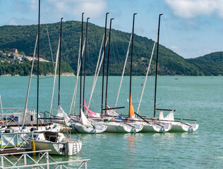 Group of anchored sailing yachts for regatta at water background