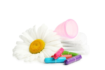 Fototapeta na wymiar Tampons, pads, menstrual cup and chamomile flower on white background