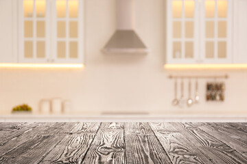 Empty wooden table and blurred view of stylish kitchen interior. Mockup for design