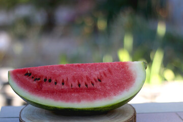 Slice of watermelon, served in a garden. Selective focus.