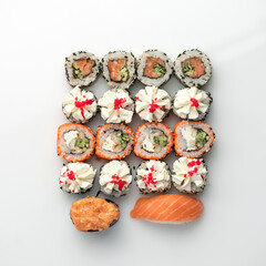 Festive Sushi and Sashimi Set, rolls isolated on white background. Classic Japanese seafood. Healthy Oriental meal. Wellness concept. Flat lay. Top view. Copy space.