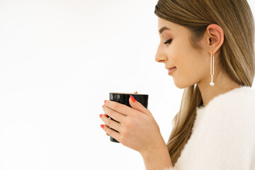 Young smiling beautiful happy woman with long hair enjoying cappuccino on white background. Beauty Woman enjoying Coffee. Cup of Hot Beverage.
