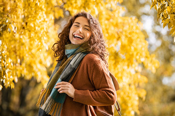 Happy girl laughing in autumn park