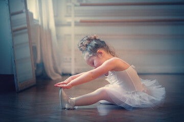 Funny little ballerina in tutu. Image with selective focus, toning and noise effect.