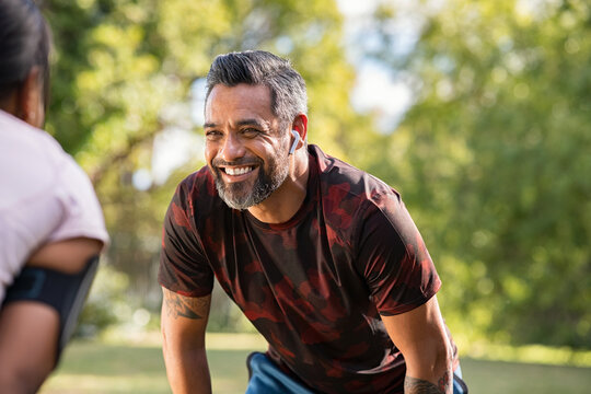 Mature mixed race man taking break after jog with his girlfriend