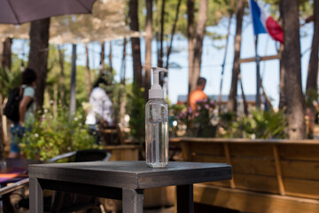 bottle of hydroalcolic gel placed at the entrance of a restaurant