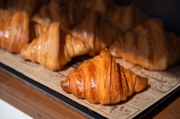 Freshly baked croissants, golden brown on paper, ready to serve in the morning.