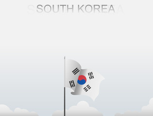 South Korea flag flutters on a pole standing tall under a white sky