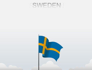 Sweden flag flutters on a pole standing tall under a white sky