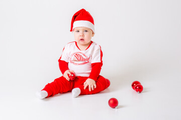 baby boy in santa hat with gifts on white background