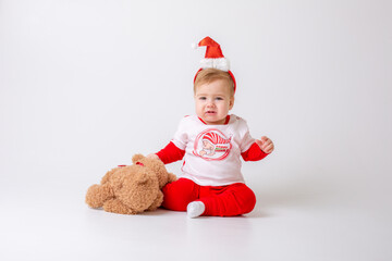 baby boy in santa hat with gifts on white background