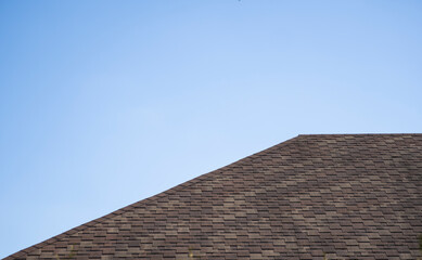 Brown corrugated metal profile roof installed on a modern house. The roof of corrugated sheet. Roofing of metal profile wavy shape. Modern roof made of metal. Metal roofing.