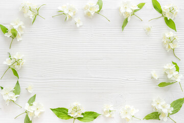 Frame of white jasmine flowers. Top view flat lay