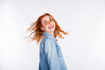Turned photo of attractive positive dreamy lady look empty space wind blow hair isolated on grey color background