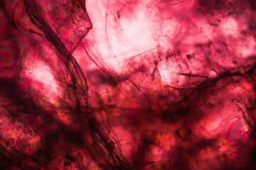 Lepidolite macro detail gemstone, close-up of the texture, grunge colorful pink purple background...