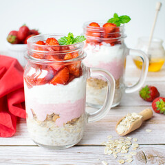 A proposal of a healthy breakfast prepared at home. Oatmeal with granola, Greek yogurt, and strawberries.