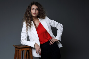 A beautiful girl in a white jacket and a red blouse