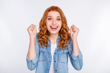 Photo of cheerful positive young woman raise fists winner shocked news isolated on grey color...