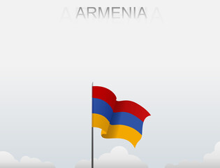 Armenian flag flutters on a pole standing tall under a white sky