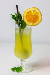 Pineapple cocktail with mint orange ice and straw