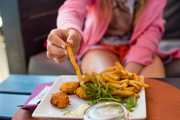 little girl feasting on her plate of fries and nuggets