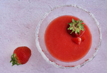 strawberry puree in a glass cream bowl with sugar and strawberry berries