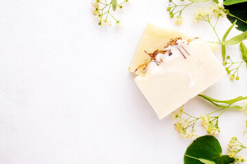 Natural soap with linden decoction on a white background with copy space, top view.