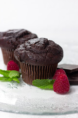 Chocolate muffin cupcake with raspberries and mint 