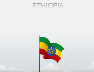Ethiopia flag flutters on a pole standing tall under a white sky