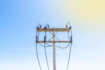 Close-up of concrete pole electric with power cable on pole for industrial use. Blue sky bright on background.