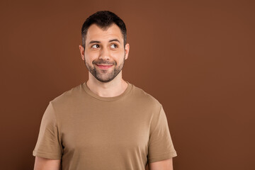 Photo portrait brunet man wearing pastel t-shirt looking blank space isolated brown color background