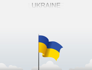 Ukraine flag flutters on a pole standing tall under a white sky