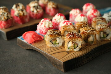 роллы унаги с угрем кунжутом васаби имбирь на доске на темном фоне