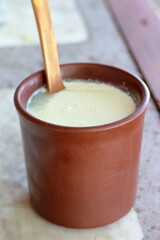 closeup of soured milk in brown clay cup