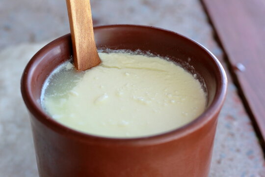closeup of soured milk in brown clay cup