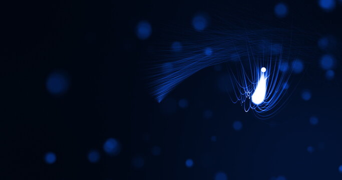 Glowing blue beams of light curving on black background with defocussed blue spots