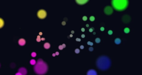 Image of multi coloured glowing spots of light moving in hypnotic motion on black background