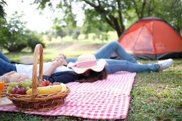 Happy couple lying camping on the nature park, in love concept.